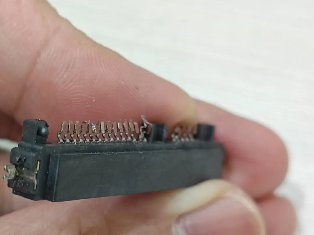 Attempting to Use a Soldering Iron to Disassemble a Circuit Board