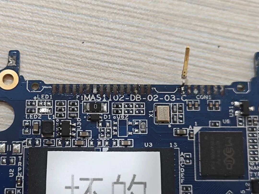 Attempting to Use a Soldering Iron to Disassemble a Circuit Board
