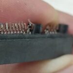 Attempting to Use a Soldering Iron to Disassemble a Circuit Board