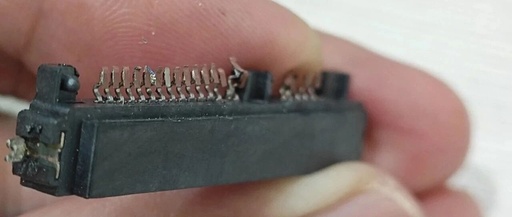 Attempting to Use a Soldering Iron to Disassemble a Circuit Board