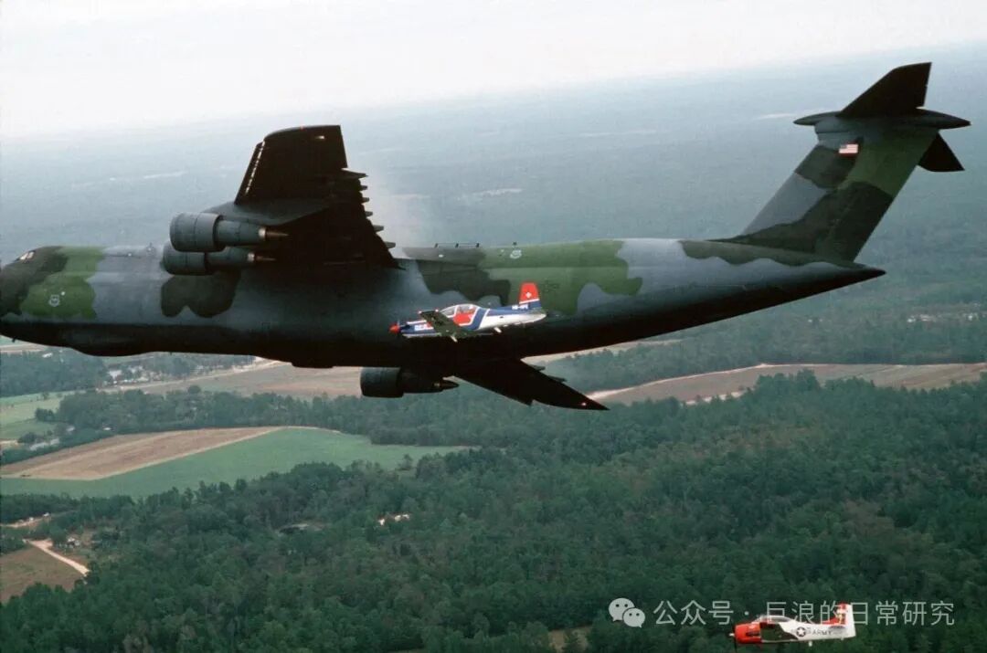 U.S. Air Force C-5 'Galaxy' Transport Aircraft and Trainer Aircraft Formation Flight